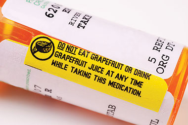 The grapefruit effect. Image of pill bottle with warning about grapefruit.
