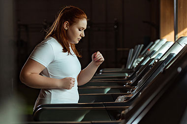Women using a treadmill.