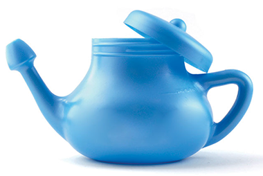 Cautions about sinus rinsing. Image of blue neti pot used to rinse nasal passages.