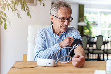 Man taking his blood pressure at home.