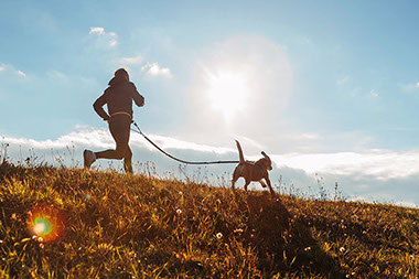 Man jogging with his dog.