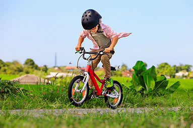 Young child riding a bike.