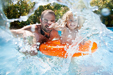 Image of father and child playing in the pool.