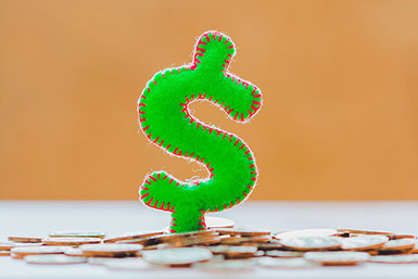Money sign standing on top of coins. Money sign standing on top of coins.