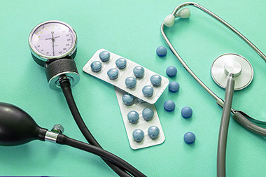 Part of a blood pressure cuff and medications.