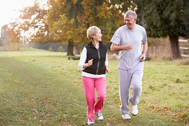 Image of couple power walking.