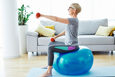 Women at home, exercising with a fitness ball. Women at home, exercising with a fitness ball.