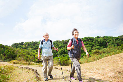 Image of an older Asian couple walking.