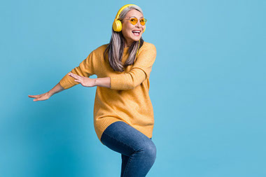 Women wearing head phones in a dance position.