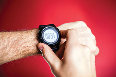 Image of man's wrist with stop watch on.