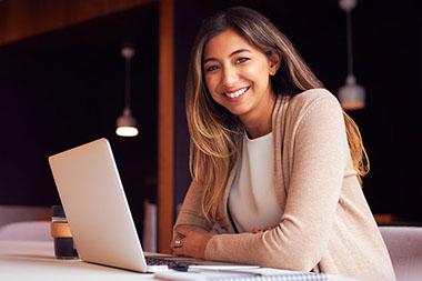 Smiling women with laptop.