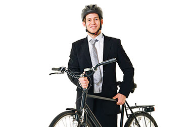 Ride your bike to work. Image of young man in a business suit with a bike and helmet on.