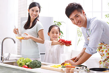 Living simply. Image of young family cooking.