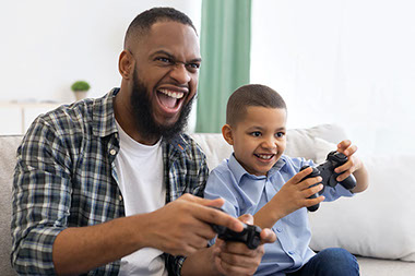 Father and son playing video games. Father and son playing video games.