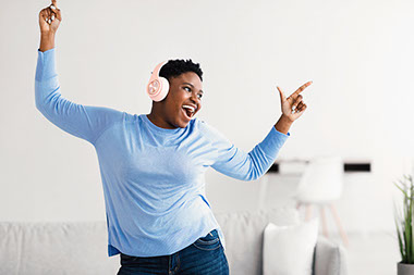 Women with headphones on, singing and dancing. Women with headphones on, singing and dancing.