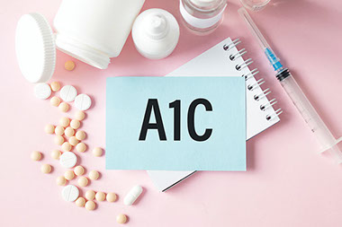 Paper with A1C printed along with pills and syringe.