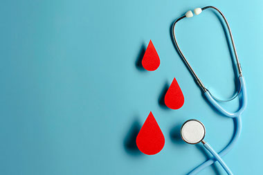 Paper cutouts of blood drops with stethoscopes.