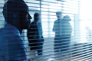 Difficult people in the workplace. Image of a business man looking off the distance.