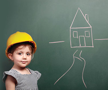 Image of child with a hard hat on an a drawing of a house.