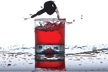 Even when drinking stops, alcohol's effect do not. Image of an alcoholic drink with a car key.