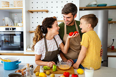 Young family cooking together in kitchen. Young family cooking together in kitchen.