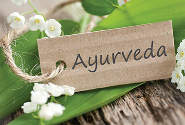 Image of leaf with tag that has the word "Ayurveda"
