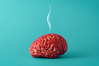 Model brain with a puff of smoke above it.