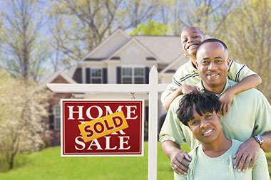 Image of family in front of their new house.