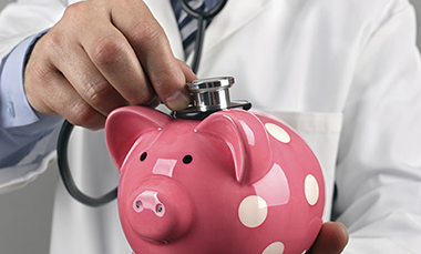 Image of doctor and piggy bank.