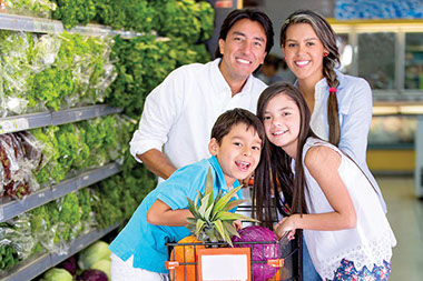 Family of four grocery shopping.