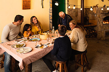 Family sitting around table eating.