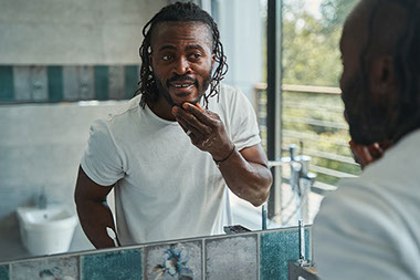 Man looking at himself in mirror. Man looking at himself in mirror.