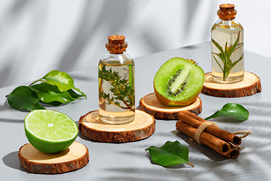 Slices of lime and kiwi, with bottles of oil and herbs.