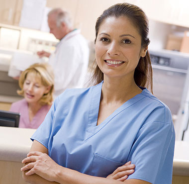 Image of nurse standing in front of the nurse station.