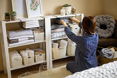 Women organizing linens in baskets. Women organizing linens in baskets.