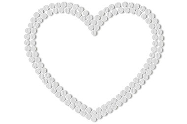Can an aspirin a day prevent a heart attack or stroke? Image of aspirins shaped into a heart.