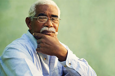 Know the facts about Alzheimer's disease. Image of elderly man with hand on chin.