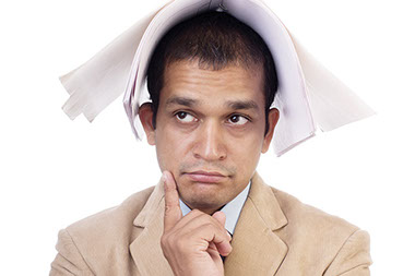 Recognize and treat early signs of burnout. Image of business man with a notebook over his head.