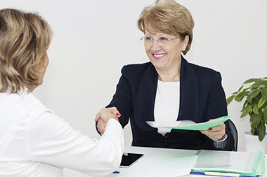 Image of 2 business women shaking hands.