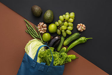 Bag with variety of veggies and fruit.
