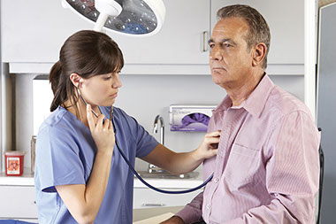Image of doctor listening to patient's heart.