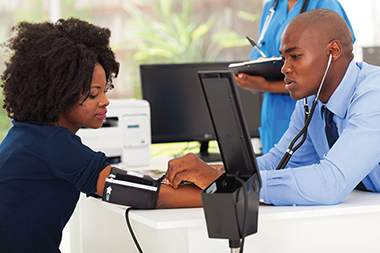Image of women having her blood pressure checked.