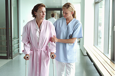 Save on hospital services. Image of nurse helping a women walk.