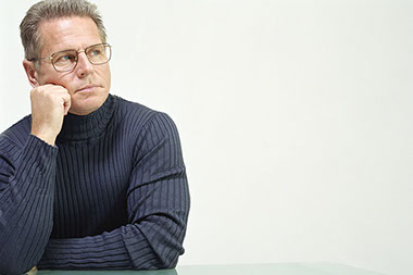 Don't fall for health fraud scams. Image of middle-aged man thinking.