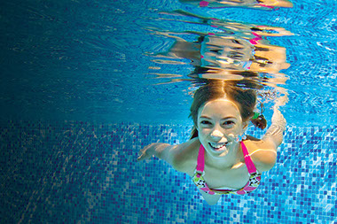 Image of girl swimming under water.