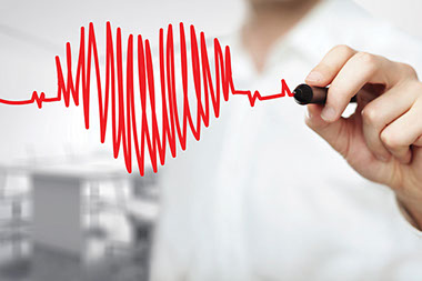 Why AFib matters. Close up image of a doctor's hand drawing a heart with heart beats.