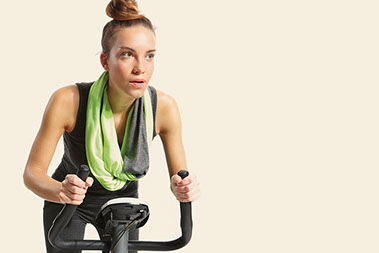 Women riding stationary bike.