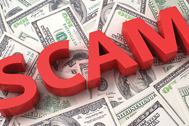 Image of the word 'Scam' spread across money.