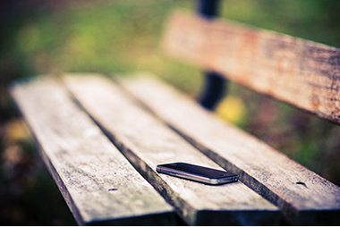 I love my cellphone. Image of a smart phone on a bench.