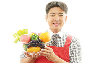 Wash and eat. Image of man holding a bowl of fruit.